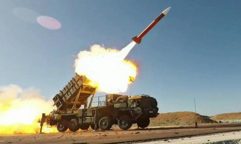 A Patriot missile launcher firing a missile outdoors during daytime